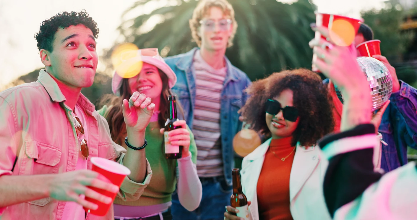 Dance, drink and party with friends outdoor together for bonding, celebration or social gathering. Alcohol, fun and reunion with group of people in backyard of home for energy, holiday or weekend