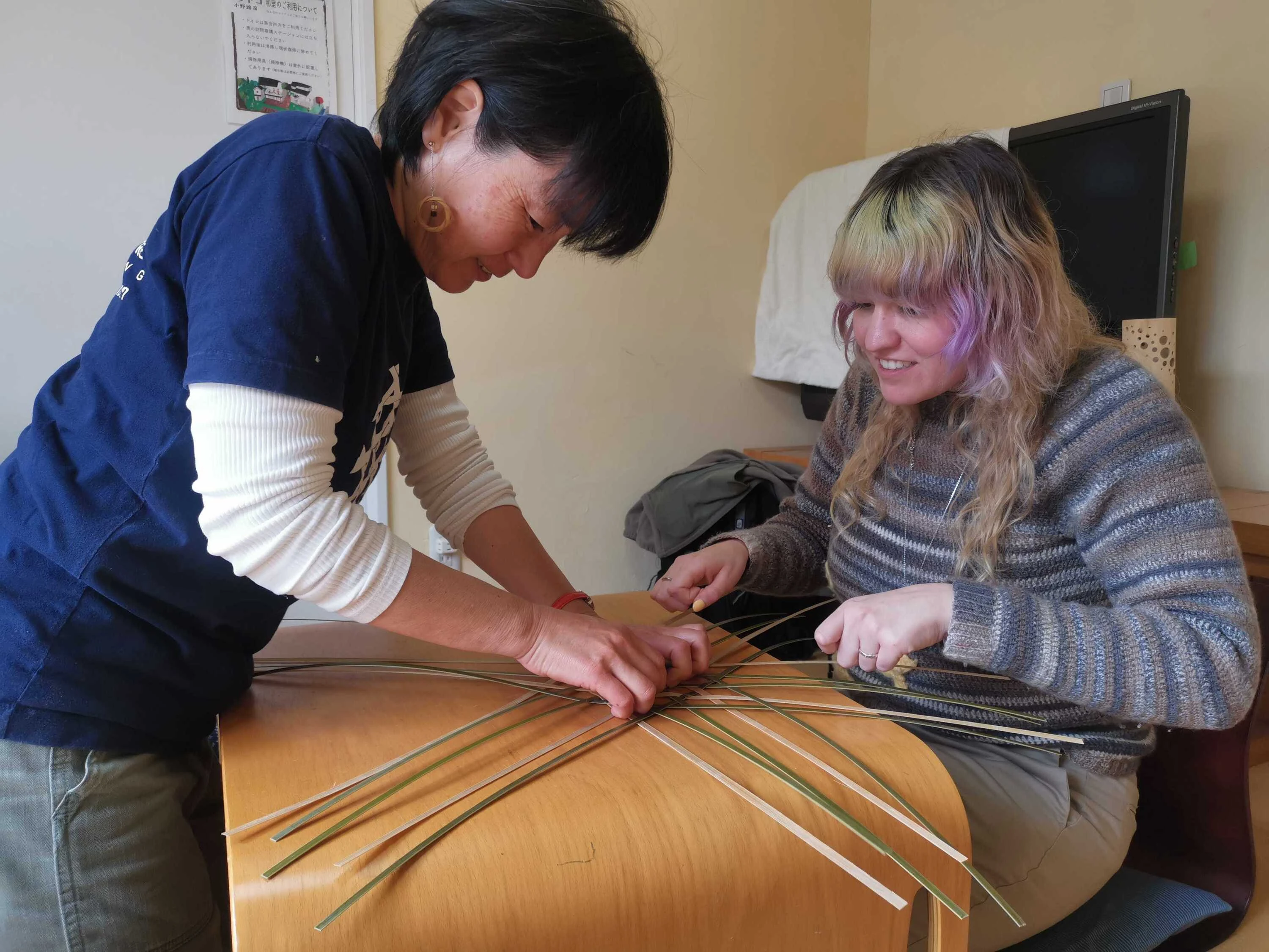Yukino helping a bamboo workshop participant
