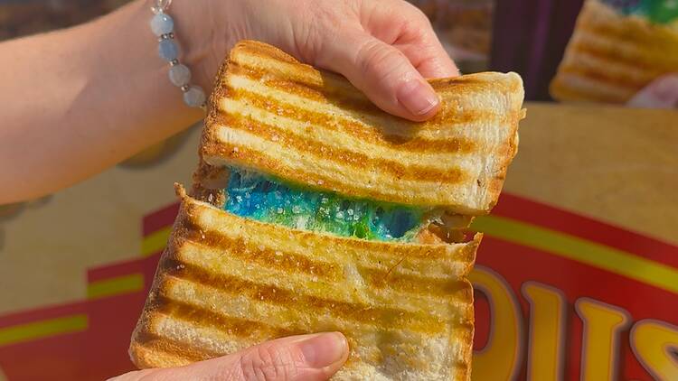 A toasted sandwich with blue-coloured cheese