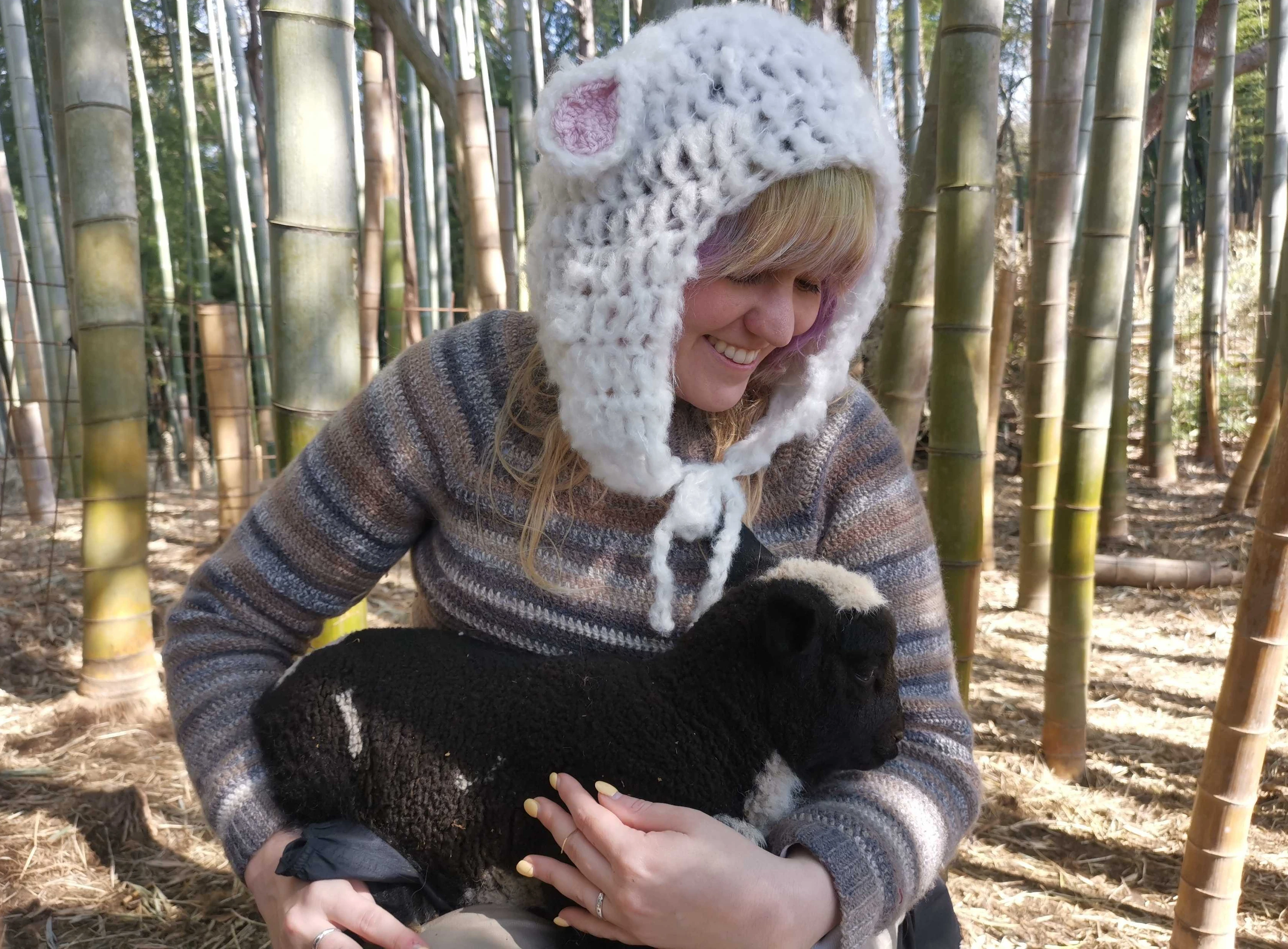 Tour participant holding lamb