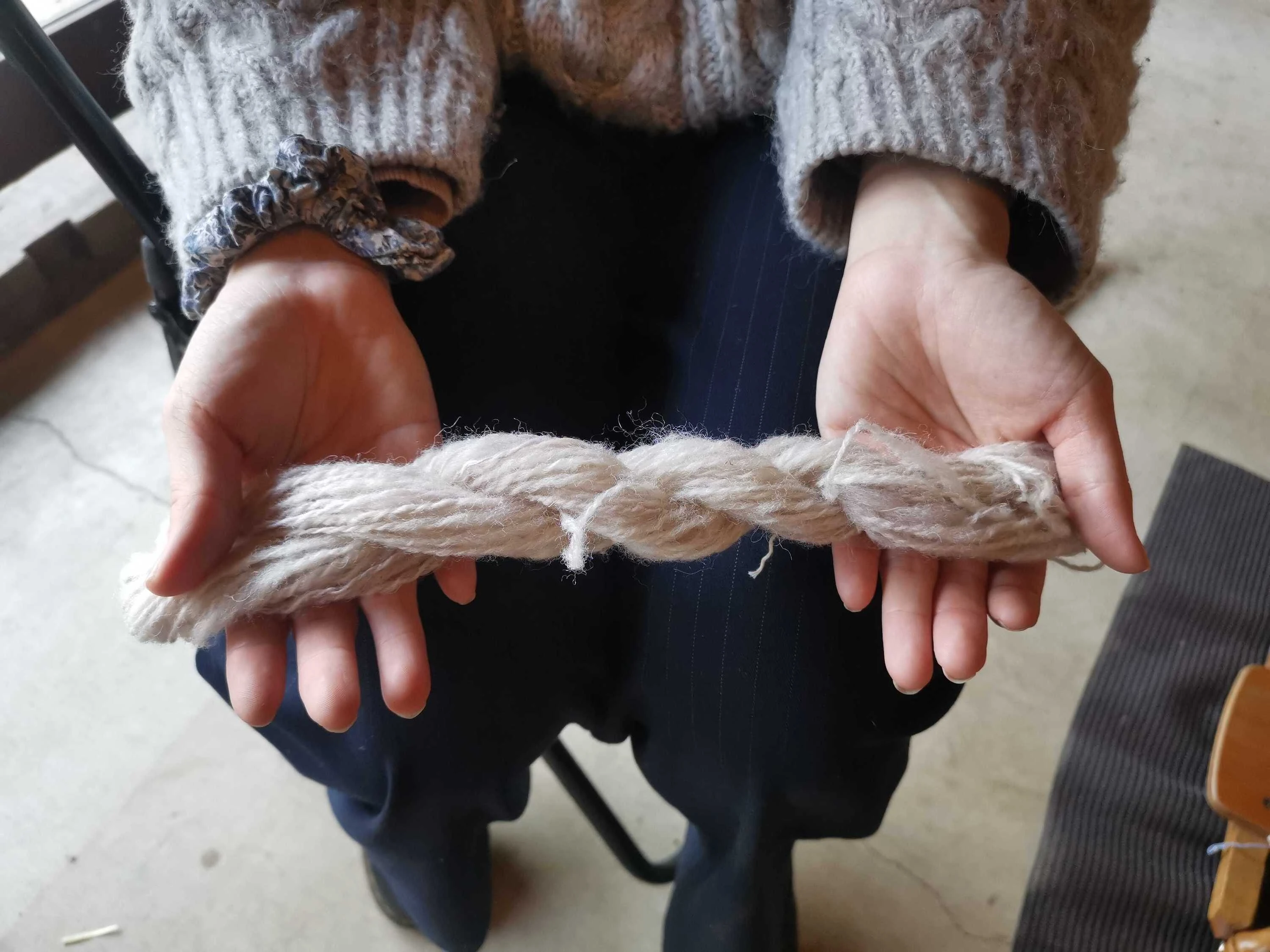 Tour participant holding spun wool