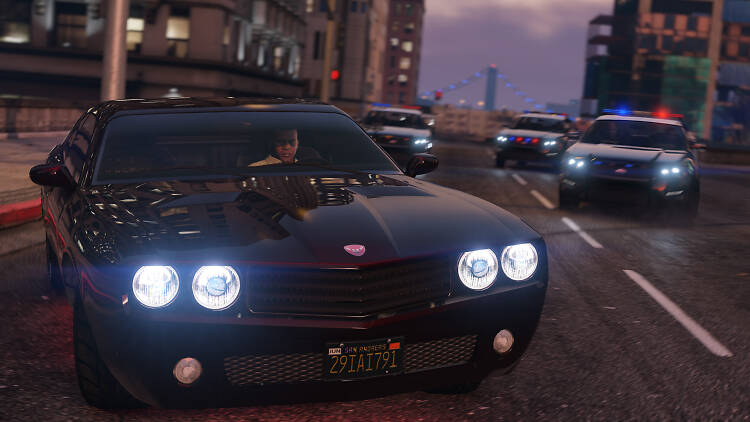 screenshot from GTA V shows a character behind the wheel of a sports car