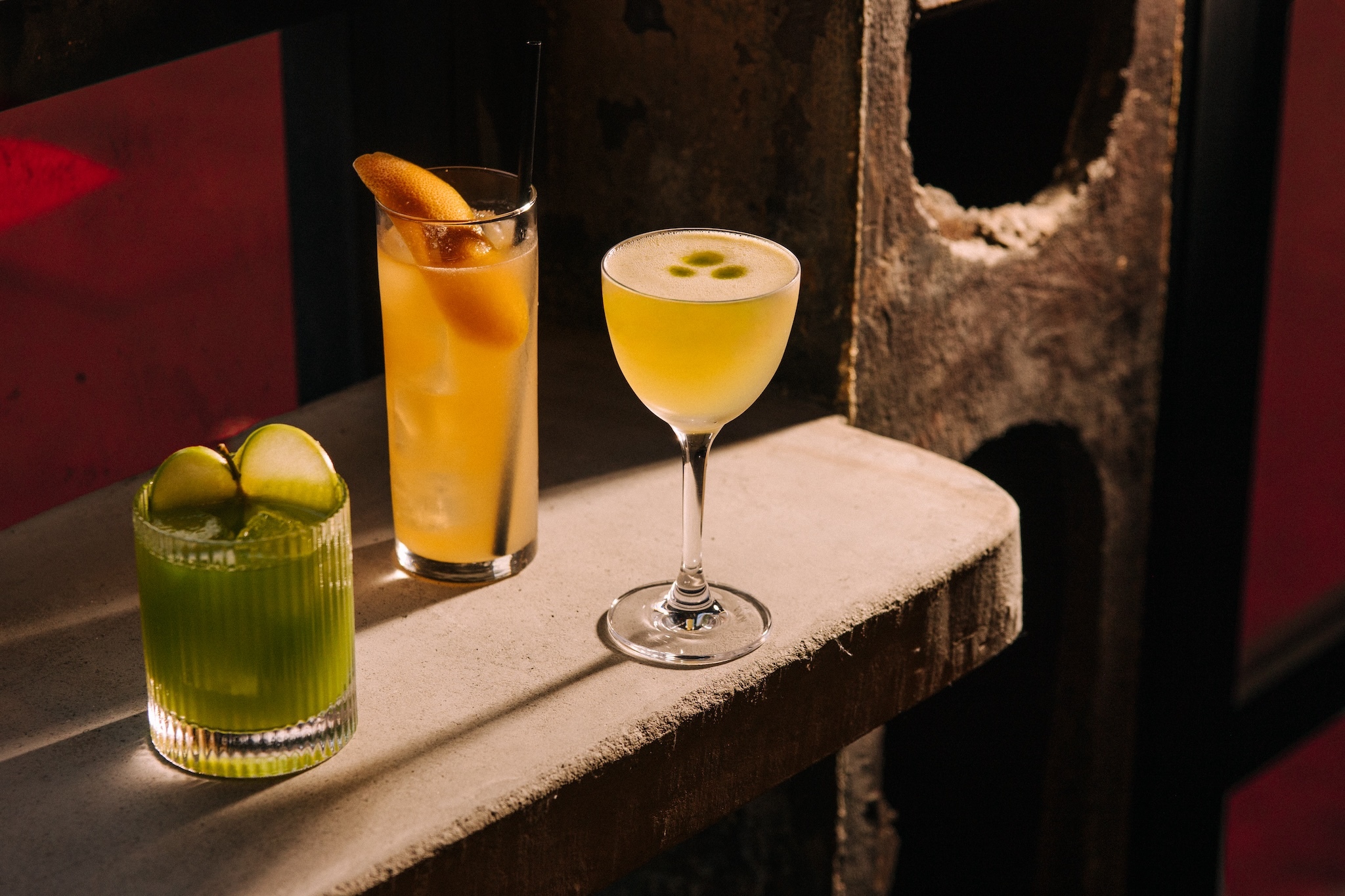 Three drinks on a concrete bar