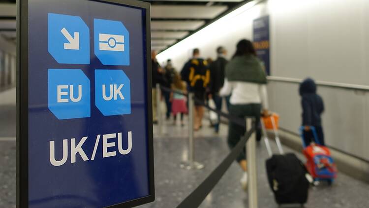 View of a generic UK and EU lane sign as air travellers proceed to border control at an airport