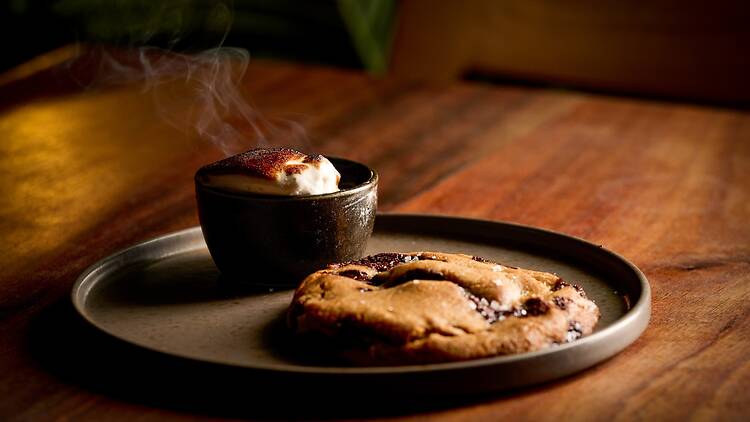 A cookie on a plate with marshmellow fluff