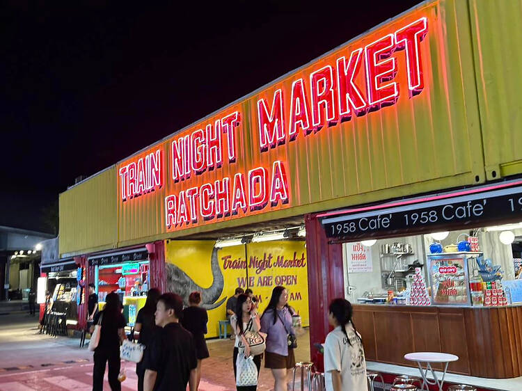 Browse rows of B100 tees and cheap shoes at Ratchada Train Night Market