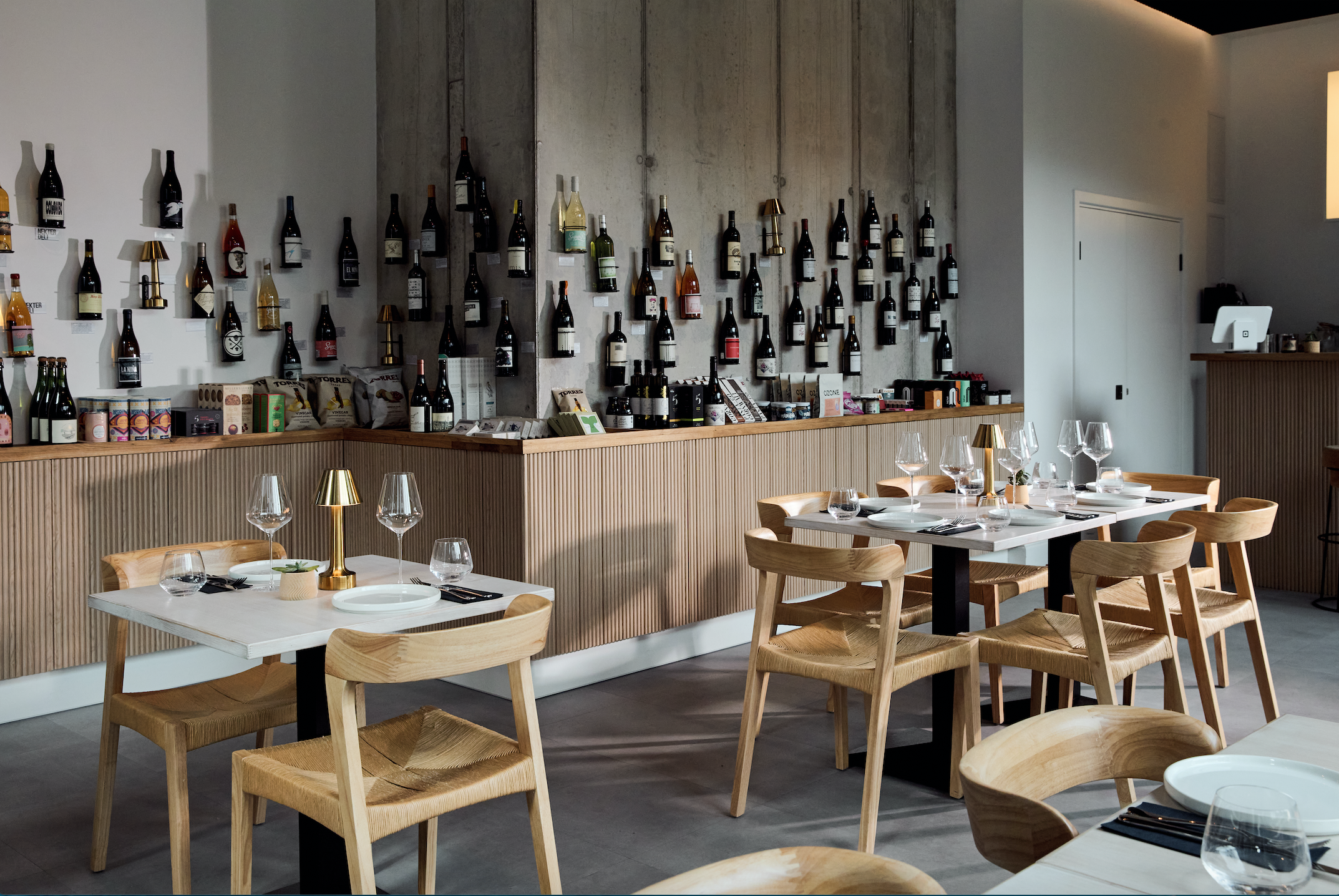Tables and a wall of wines at Nekter Deli in Shoreditch