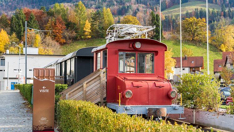 Maison Cailler chocolate factory outdoor vintage red electric locomotive display Maison Cailler chocolate factory outdoor vintage red electric locomotive display