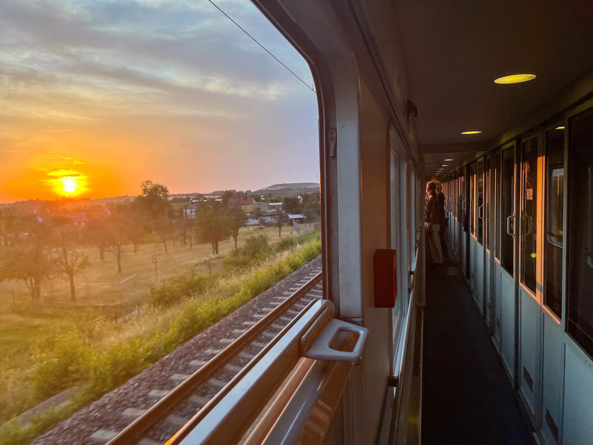 People looking out a window on a European Sleeper train