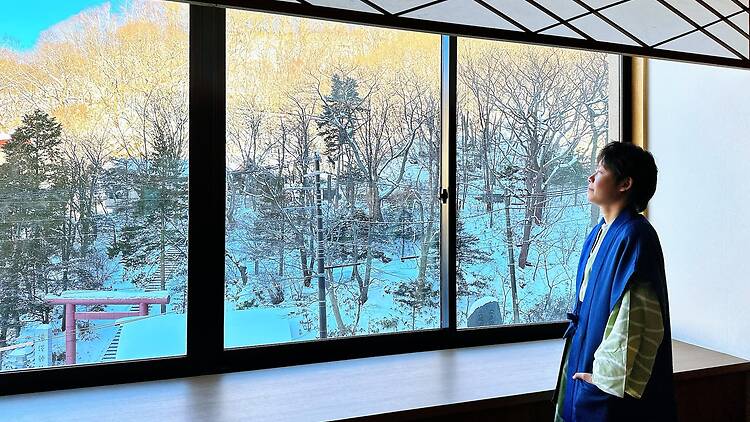 Hokkaido, Japan - July 13 ,2022:  Asian lady wearing japan wearing style yukata looking snow view at outside. holiday concept