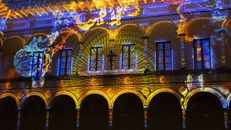 Eonarium Enlightenment A large room illuminated by colourful projections.