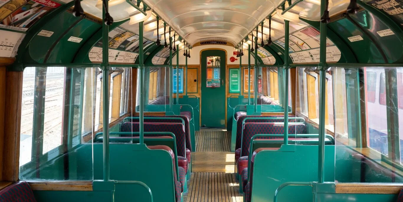 Inside carriage of 1938 tube train with red and green seating