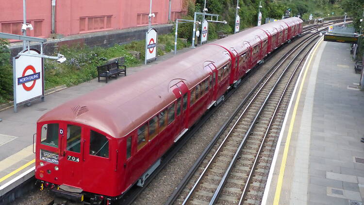 All four carriages of the vintage 1938 tube train travelling down the track
