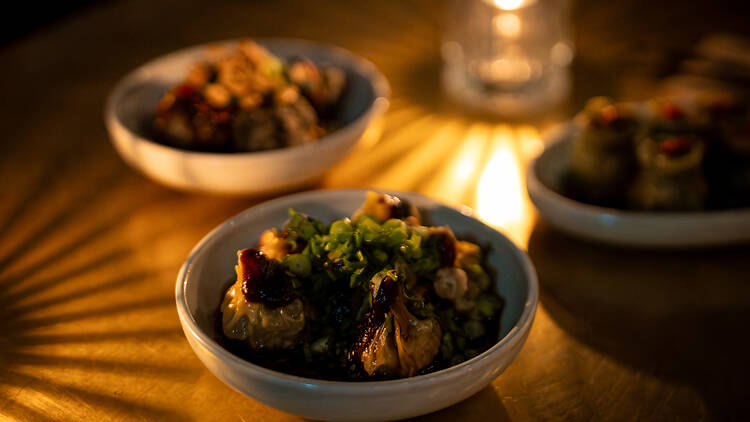 Blnd Tger dumplings on a dimly lit table Blnd Tger dumplings on a dimly lit table