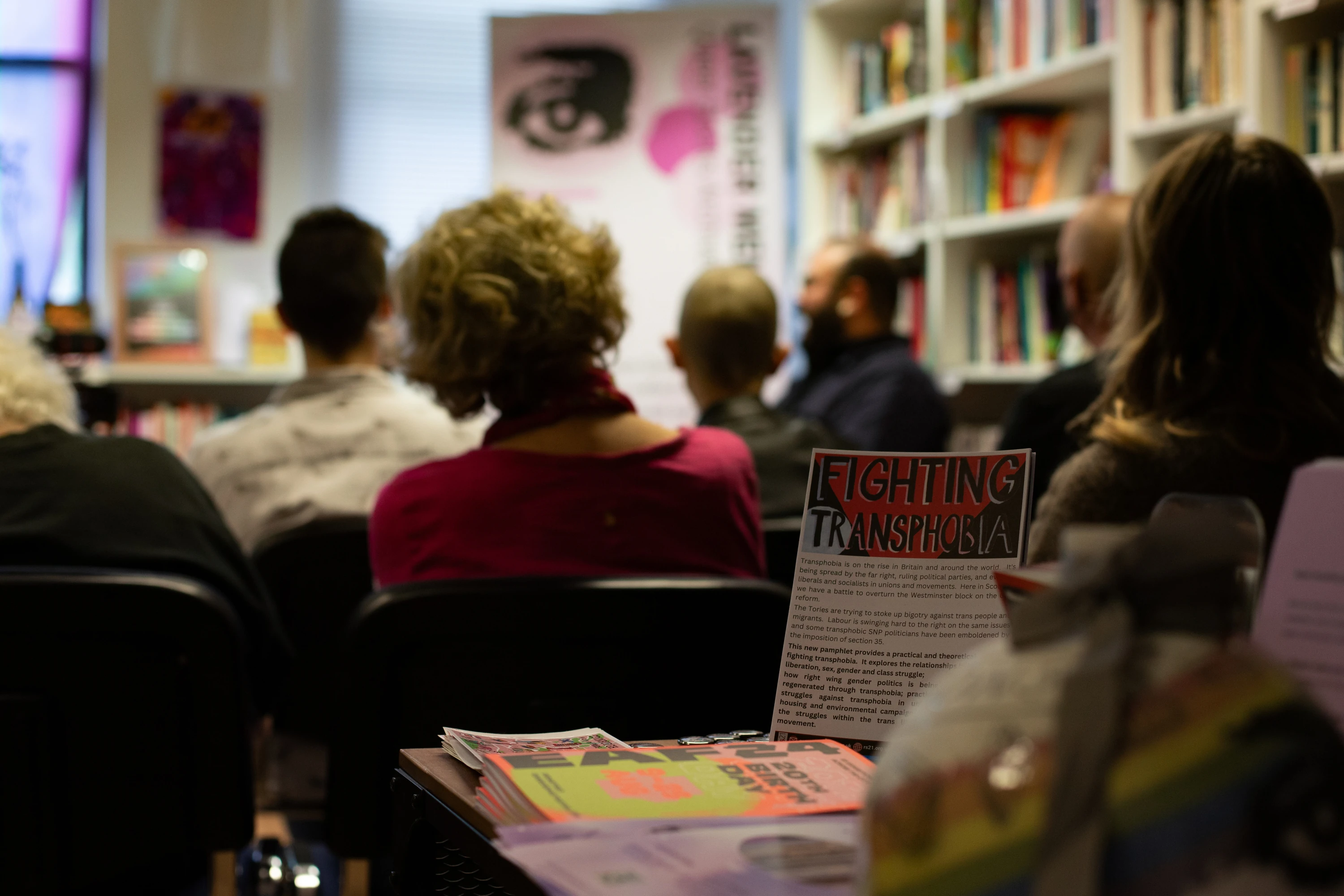 Room full of people at 'Fight Transphobia' reading