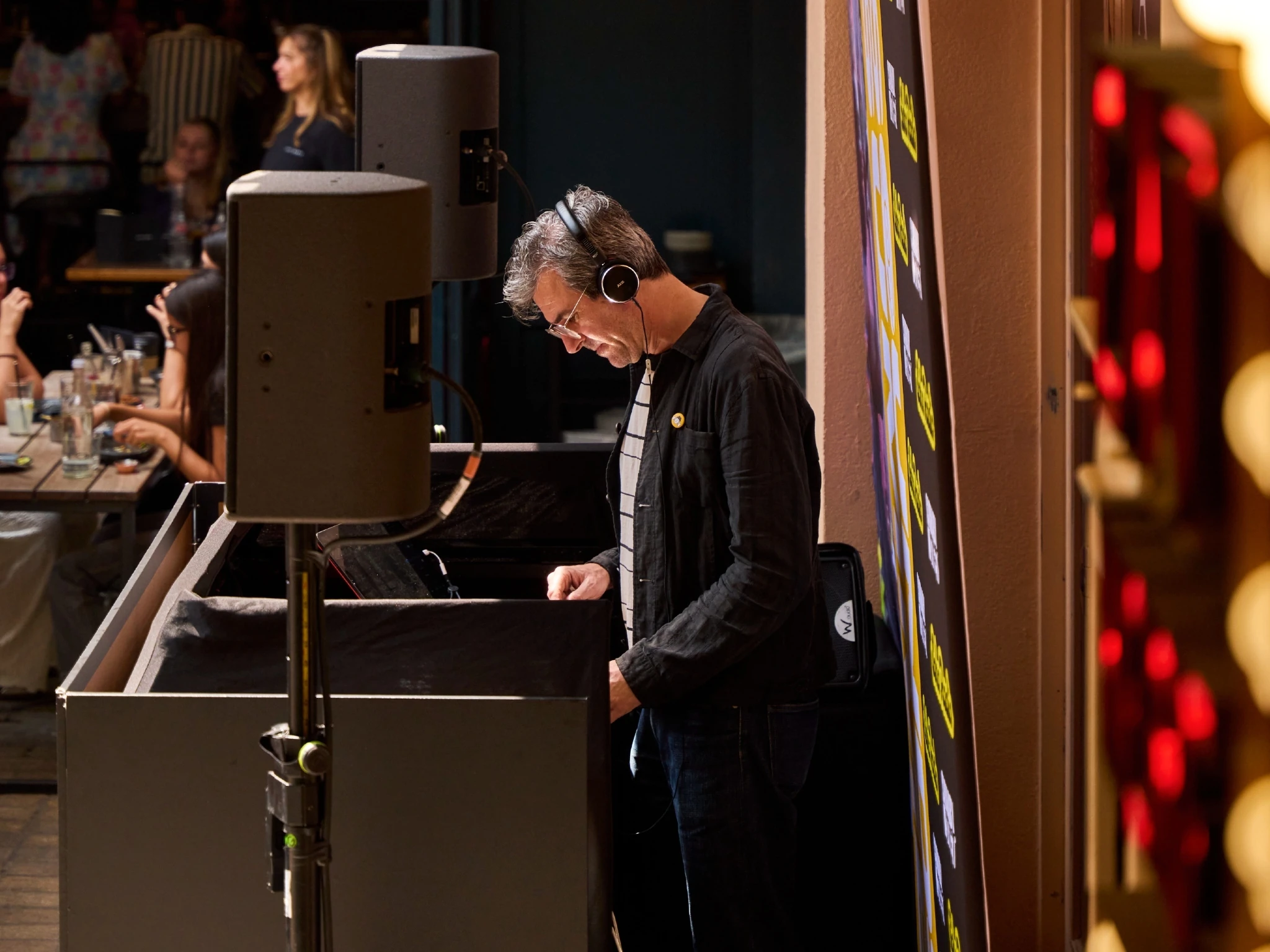 A DJ standing behind the decks at Kingly Court, Soho