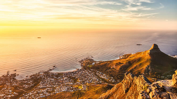 Cape Town Sunset Aerial View from Table Mountain over Camps Bay, Lion's Head and Twelve Apostles in the Background Cape Town sunset aerial view from Table Mountain over Camps Bay, Lion's Head and Twelve Apostles in the Background, South Africa