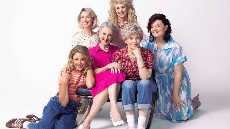 A group of women of mixed ages smiling at the camera.