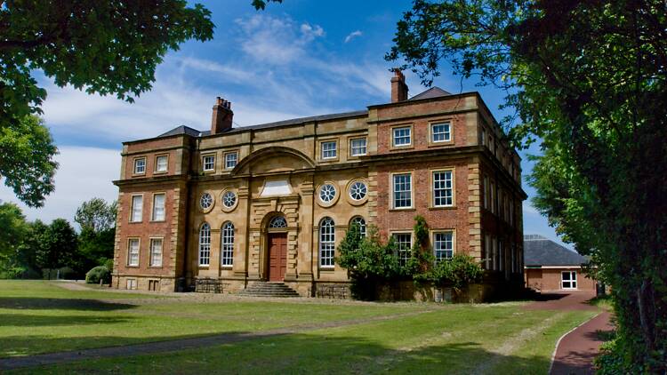 Three-storey brick building in a green field Three-storey brick building in a green field, Kirkleatham Museum in YOrkshire