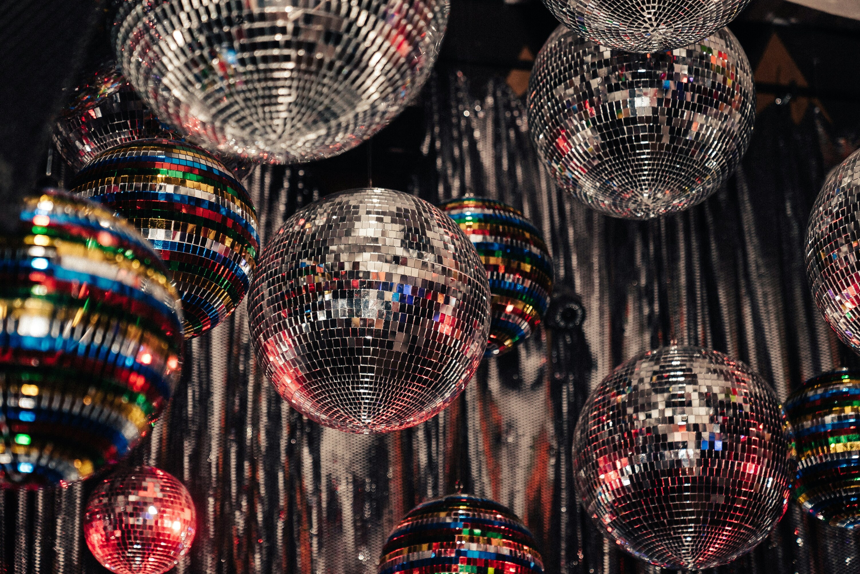 Lots of disco balls hanging from ceiling