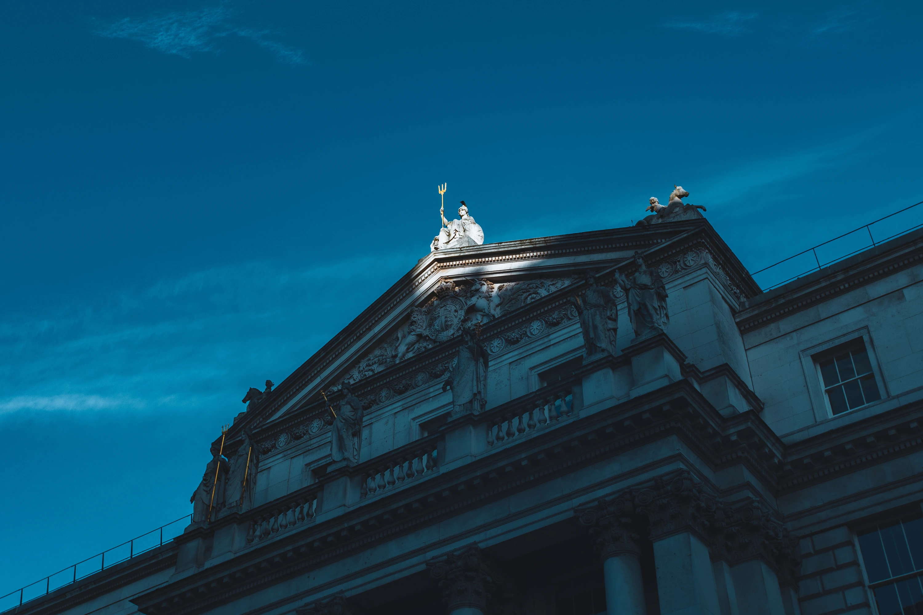 Spotlight on sculpture on the roof of Somerset House