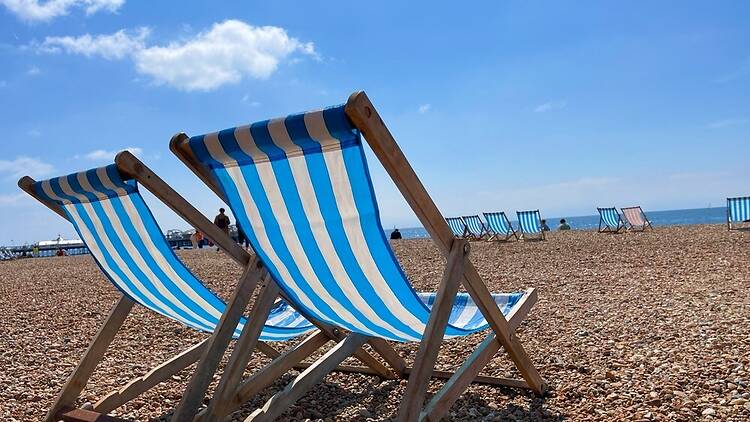 Loungers on the beach at Brighton, England