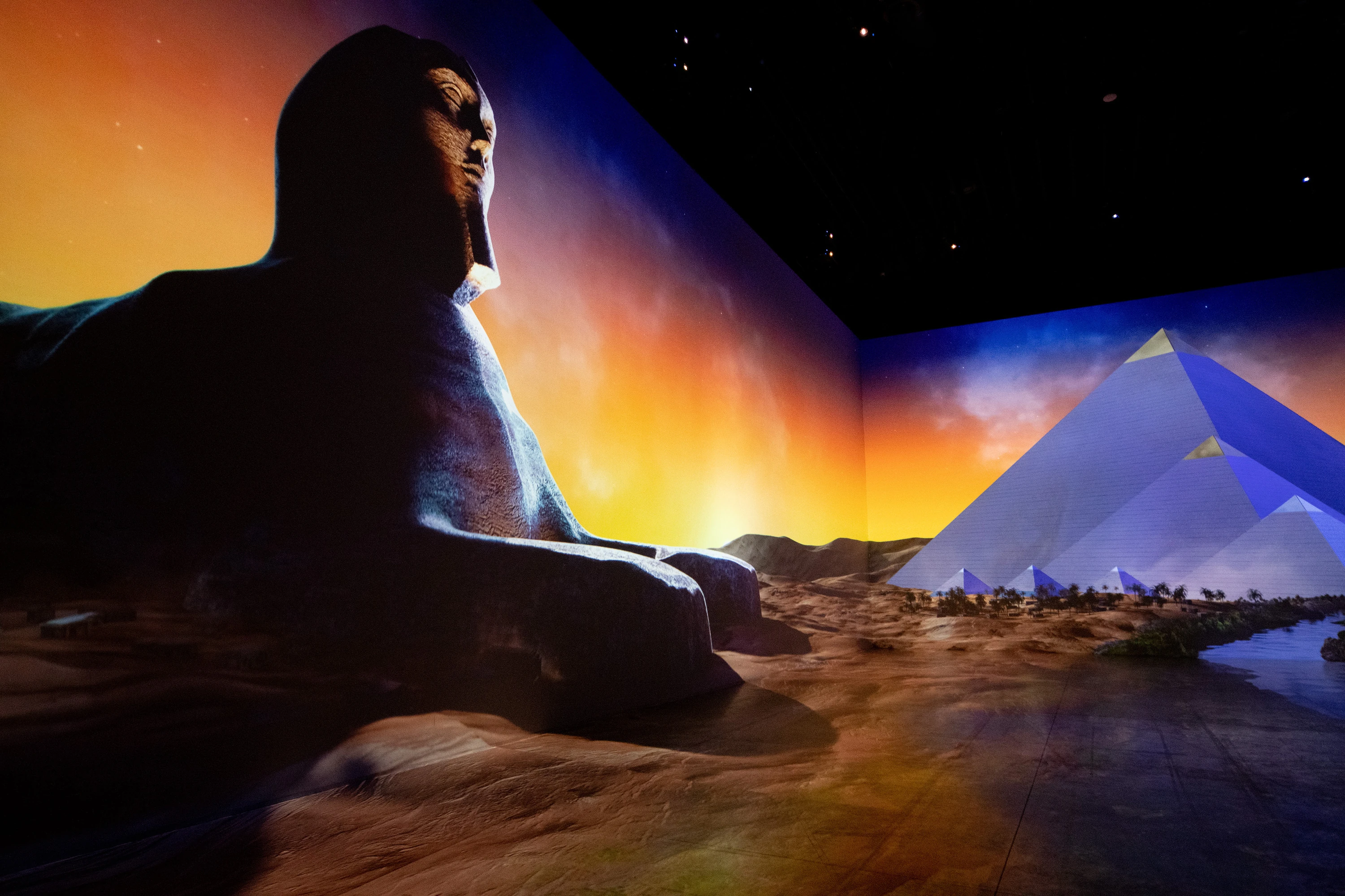 Huge screens showing ancient Egyptian sculptures