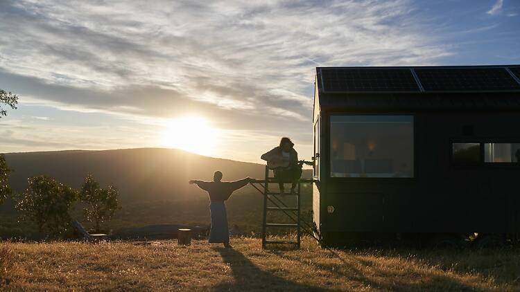 Couple outdoors near tiny home