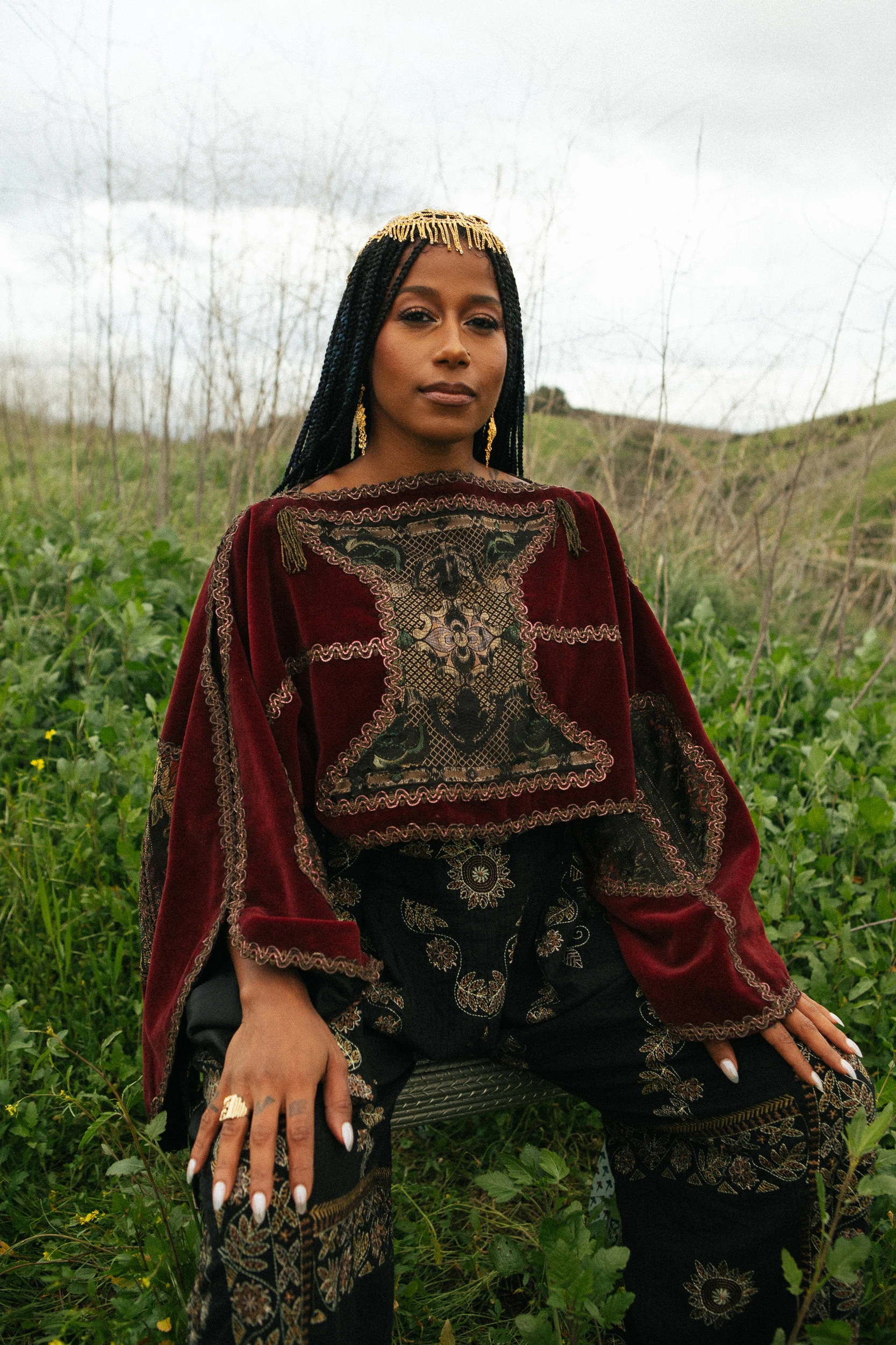 A portrait of Aja Monet in a field.