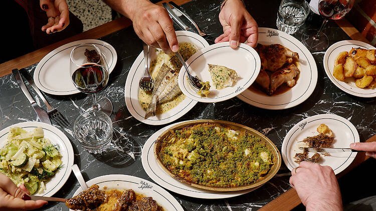 A table laden with dishes of food at Bar Sophia.