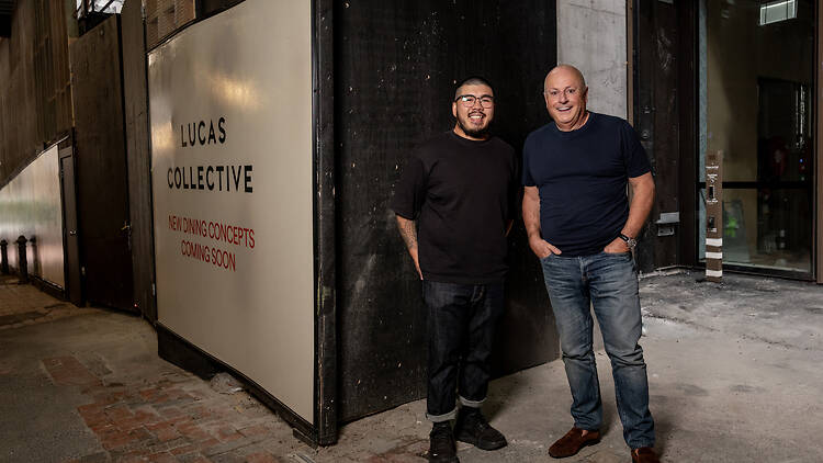 Chris Lucas and Dan Chan at a building site.