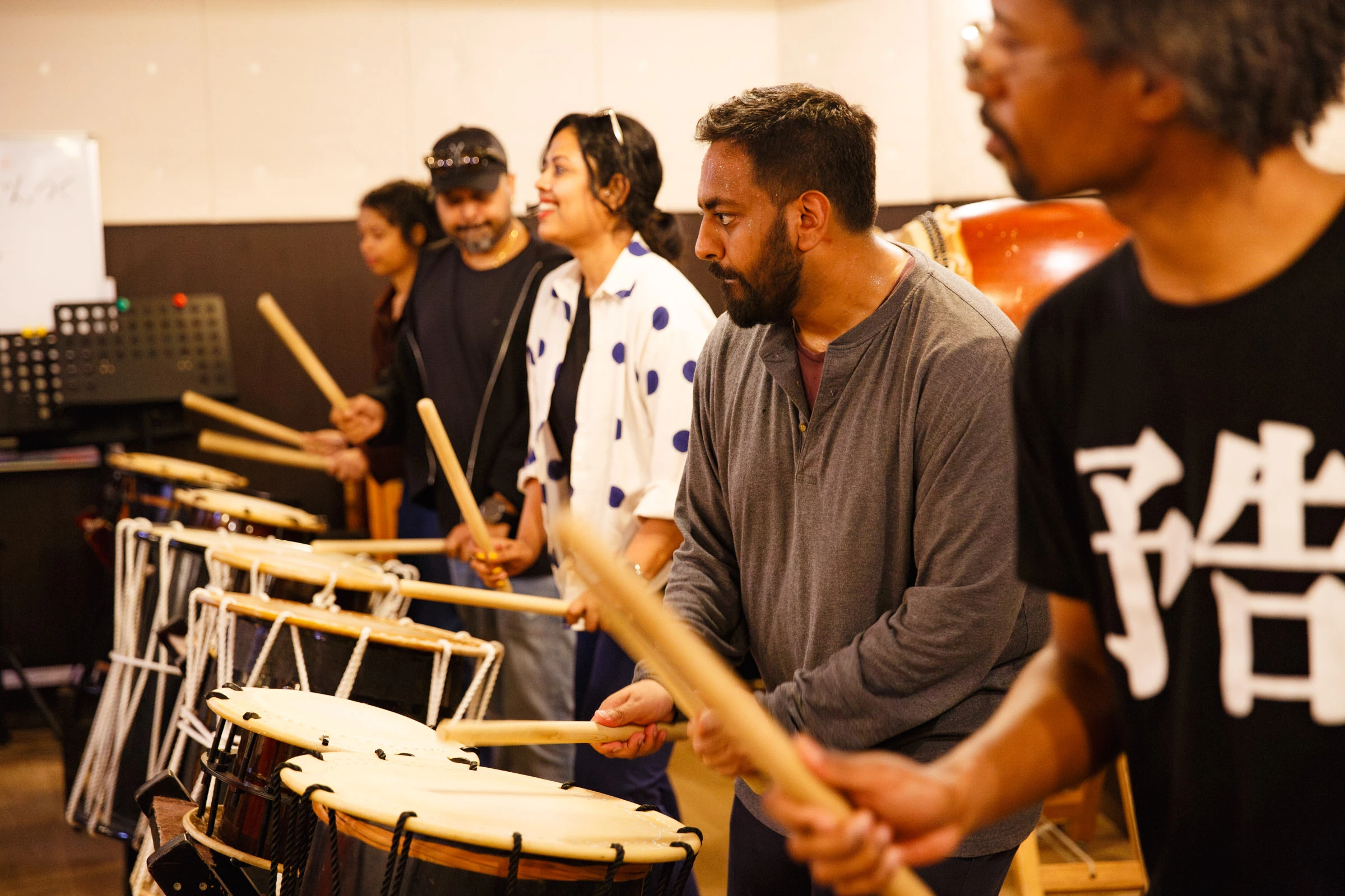 Class participants playing the taiko drum