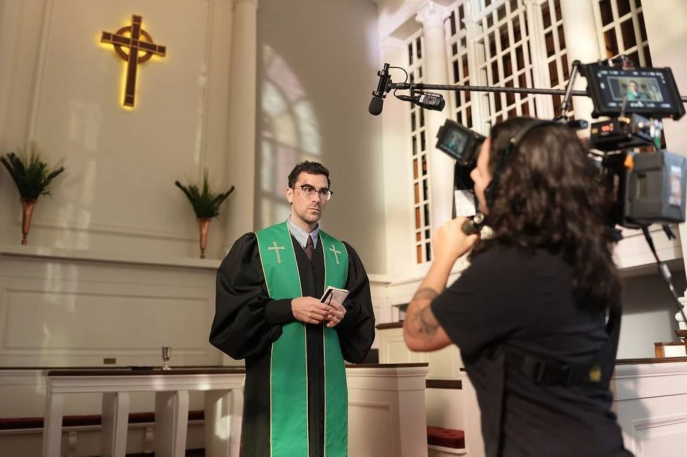Big Mistakes filmed at a real church in New Jersey. Dan Levy is pictured behind the camera in his pastor costume