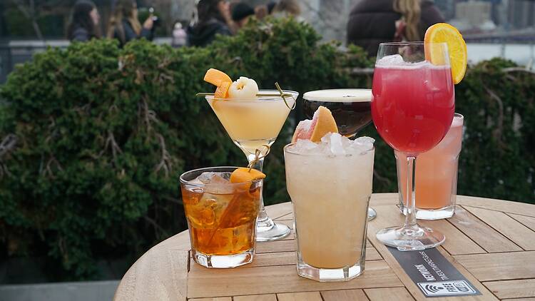 Six cocktails on a wooden table