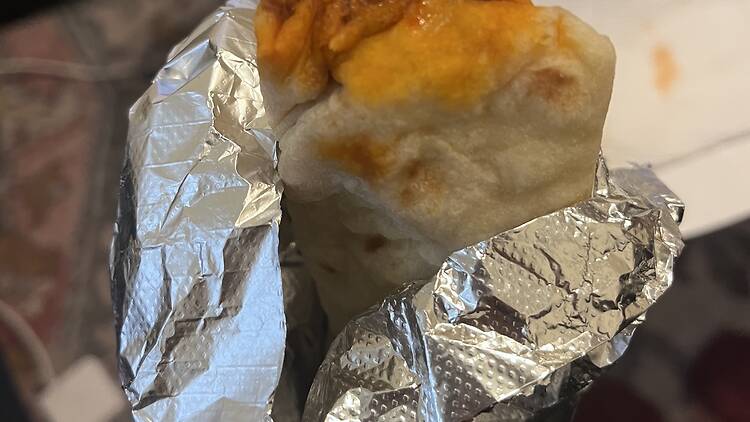 A person holding a burrito