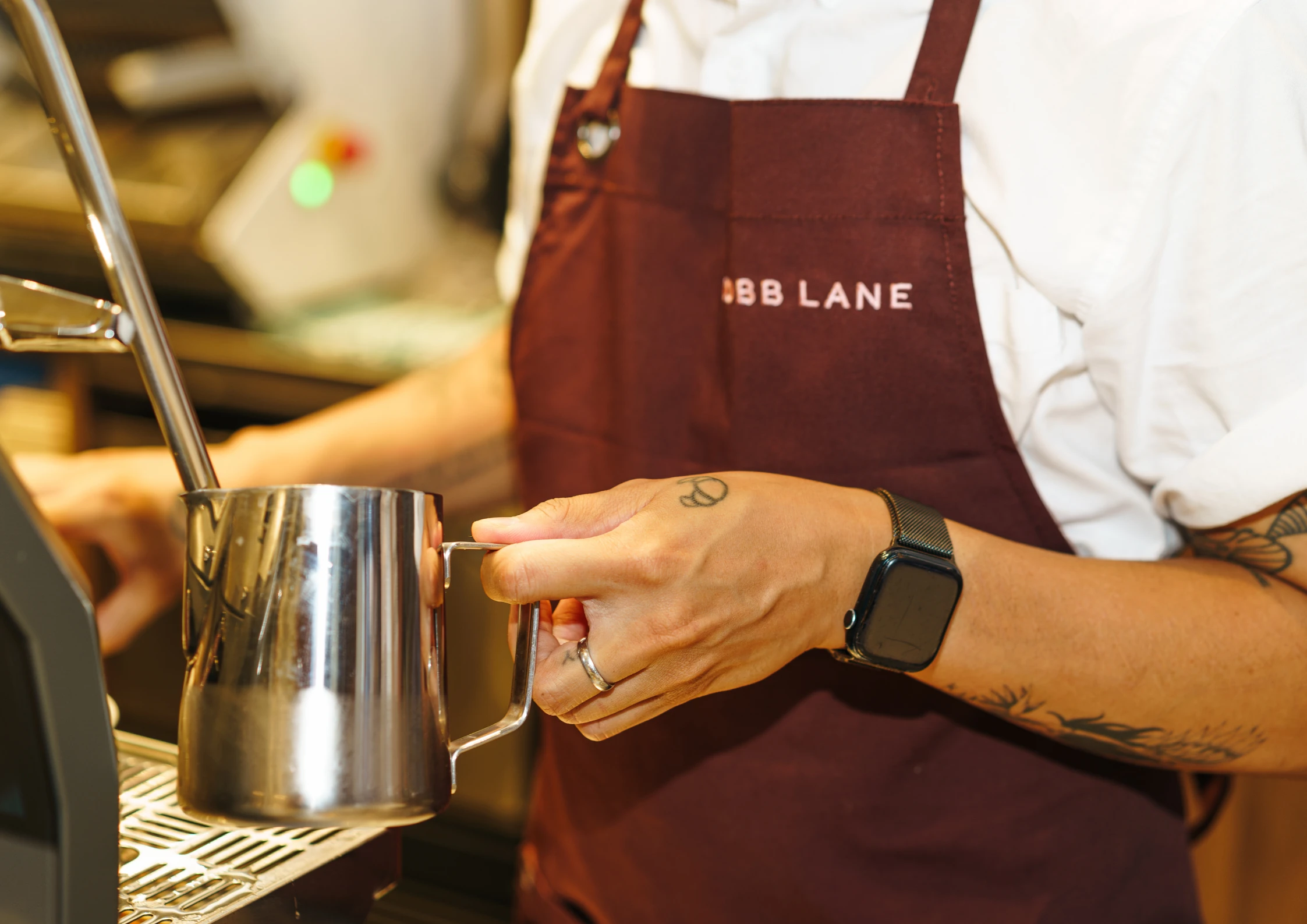 Barista frothing milk.