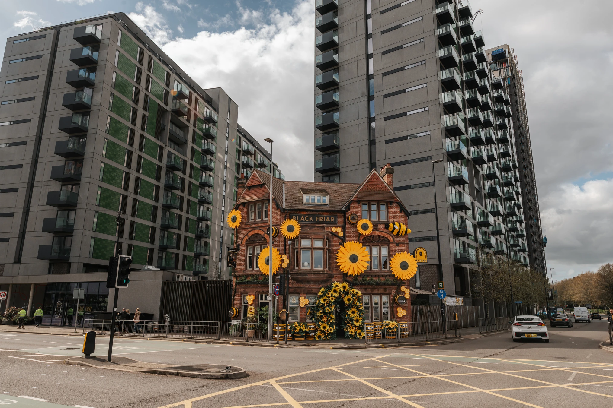 View from street of The Black Friar pub in Manchester with sunflower artwork covering the building