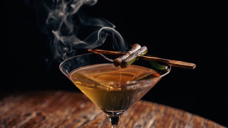 Yakitini with a smoking cinnamon stick on top