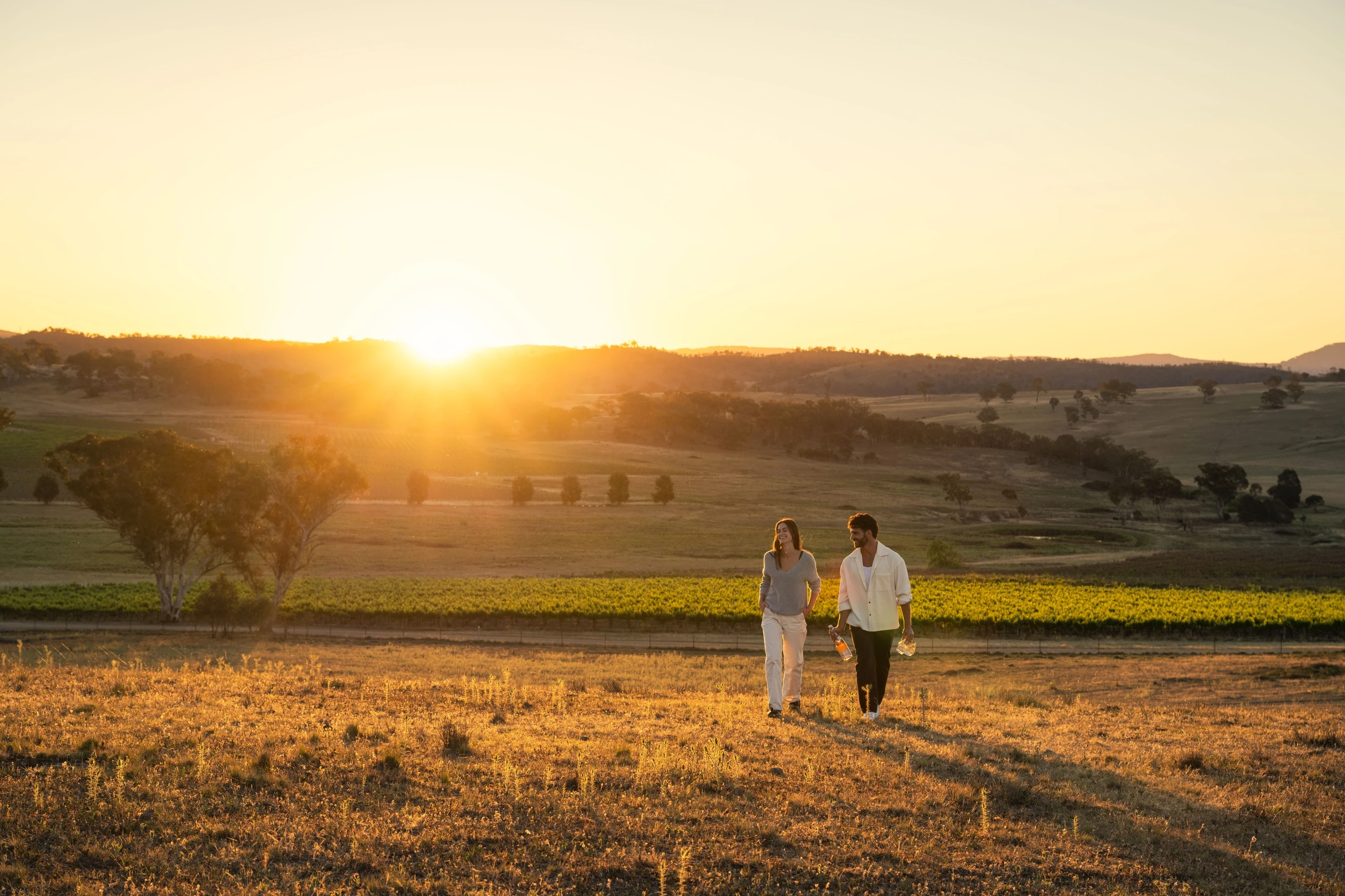Couple enjoying a walk through the vineyard at De Beaurepaire Wines in Rylstone.