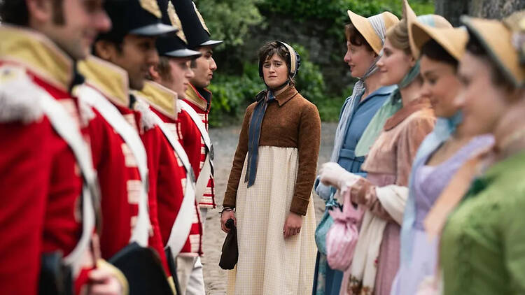 The Other Bennet Sister - Mary standing in the center back of a scene where her sisters are lined up with soldiers