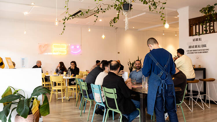 People dining inside at All Things Equal.