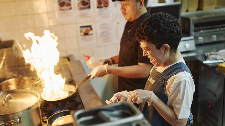 Two chefs cooking at All Things Equal.