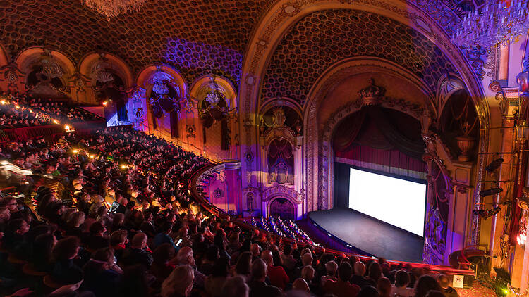 A film screening from the high balcony levels of an art deco theatre