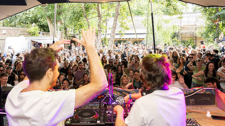 DJs and a crowd dancing outside at Fox & Firkin