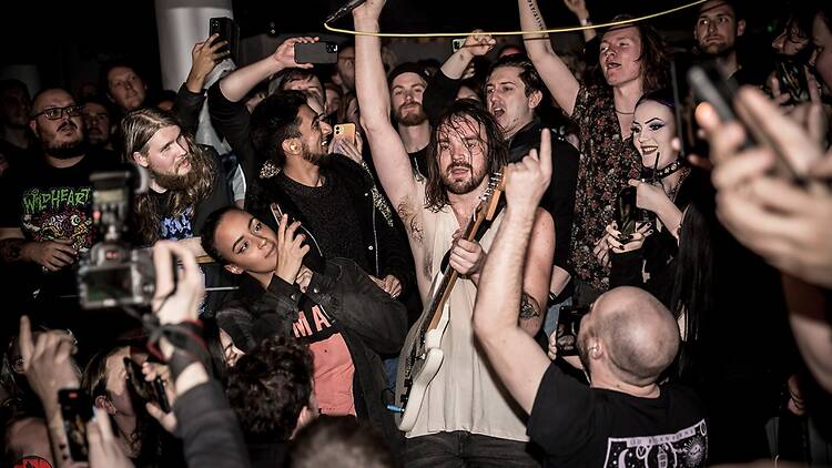 Guitarist surrounded by people in the Underworld 