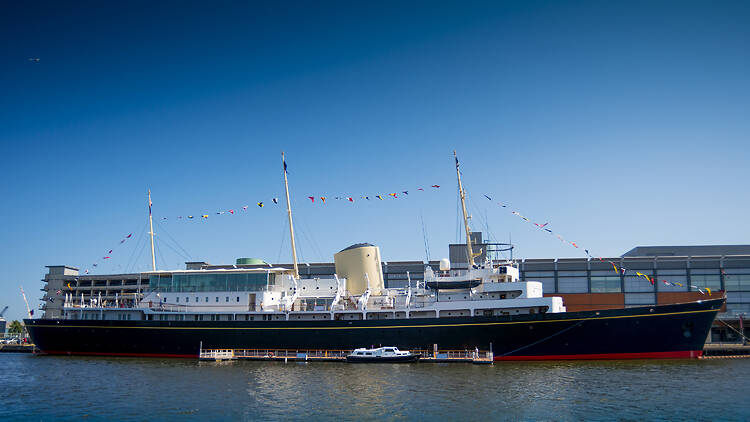 The Royal Yacht Britannia floating on the water in Leith port