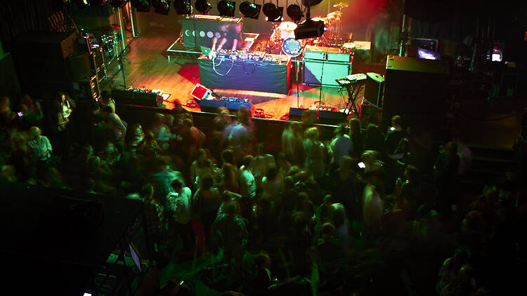 A stage set up with a full crowd at Scala
