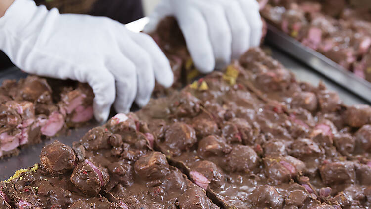 person with gloves handling Rocky Road 