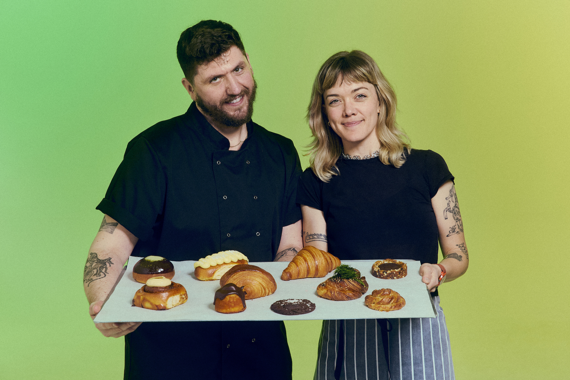 Founders of Toad Bakery holding tray of their signature pastries