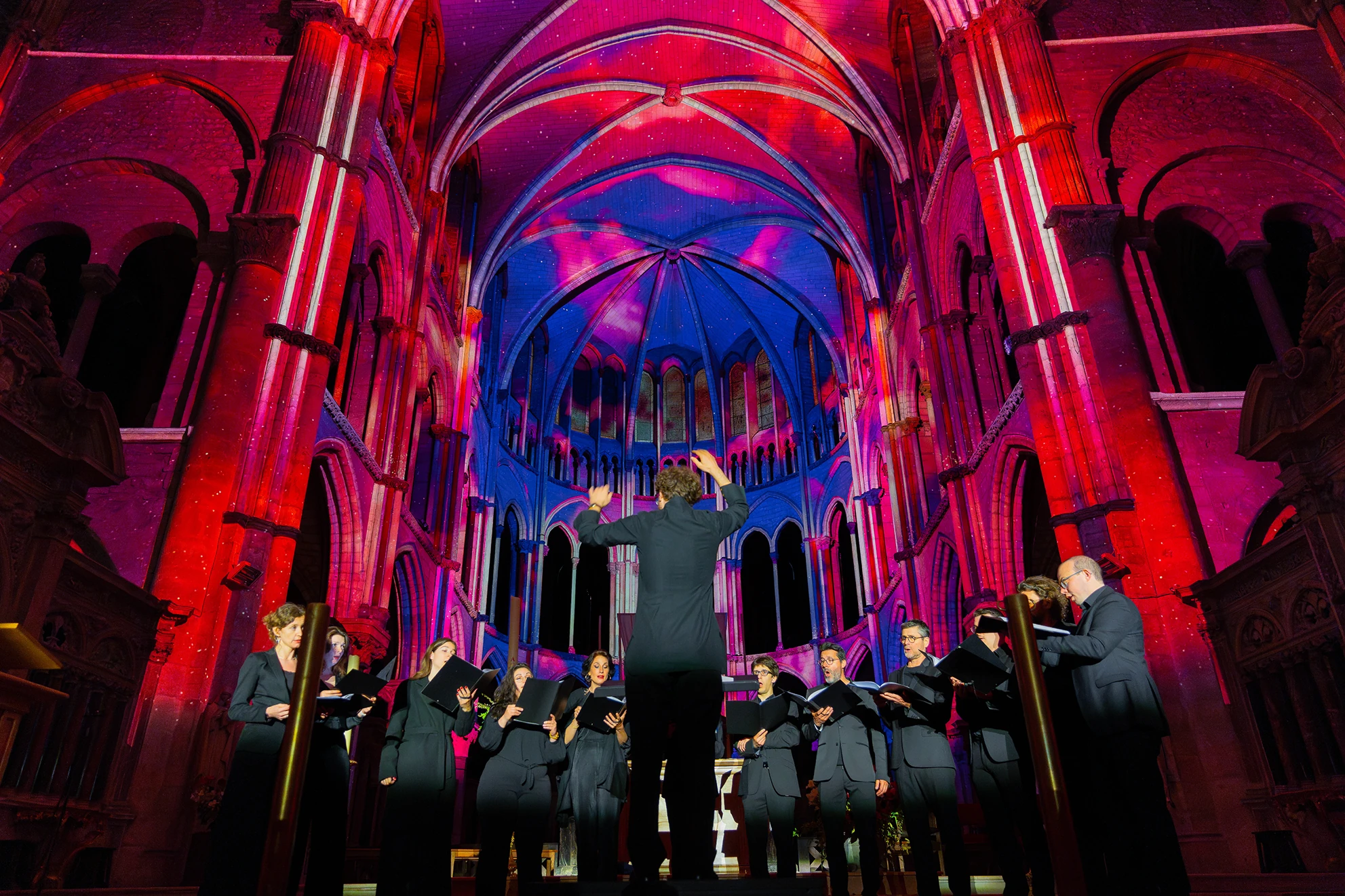 Conductor and live choir performing below light show